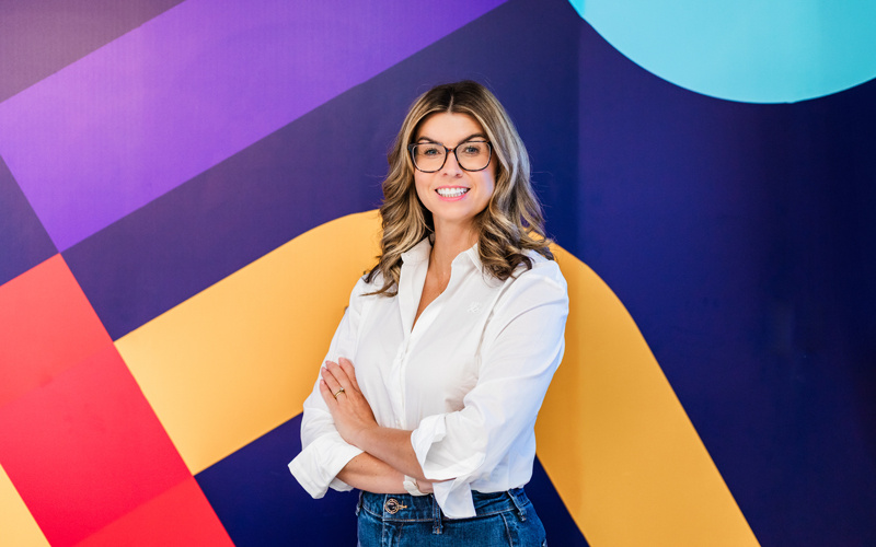 Rachael Flanagan, founder of Mrs Buckét, smiling with her arms folded